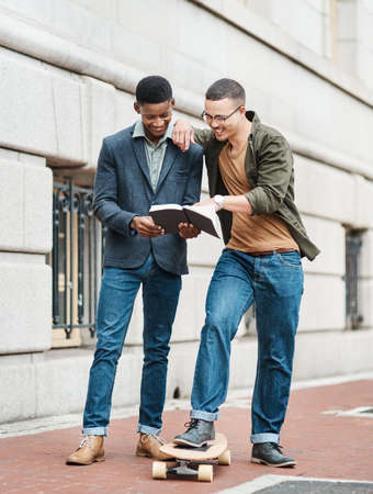 Business just keeps getting cooler. Shot of two young businessmen having an informal meeting against...