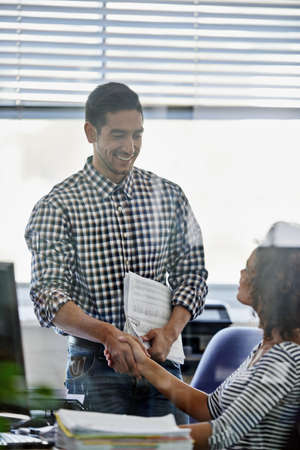 Youve got the project. Cropped shot of two young designers shaking hands.