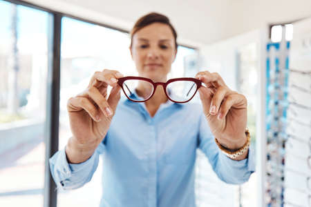 As glare free as it gets. Shot of a young woman buying a new pair of glasses at an optometrist...