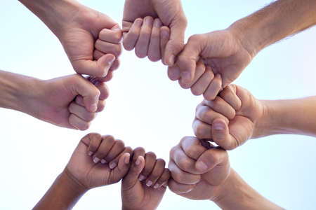 Your support is always appreciated. Shot of a group of people fist bumping one another in a circle.の写真素材