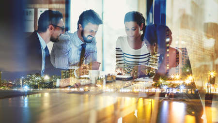 Taking their ideas online. Multiple exposure shot of a business group superimposed over a city.