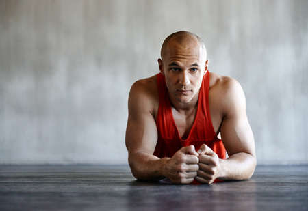Youve got to push it. Shot of a man doing a challenging workout at the gym.