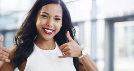 Business comes easy to me. Cropped shot of a young businesswoman showing thumbs up while walking...