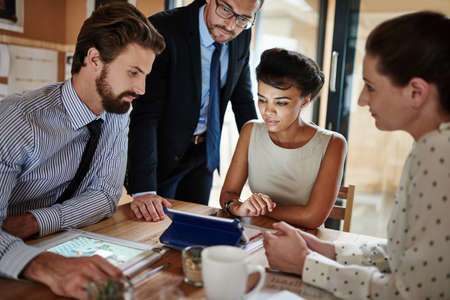 Bring ideas to life. Shot of a group of colleagues working together in an office.