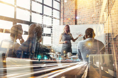 Business never stands still. Shot of corporate businesspeople in the boardroom superimposed over a...