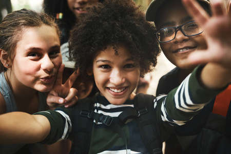 First selfie of summer camp. Shot of a group of teenagers taking a selfie at summer camp.の写真素材