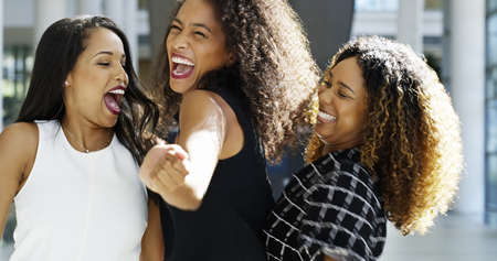 Dancing because they crushed it. Cropped shot of three attractive young businesswomen dancing happily in the workplace.の写真素材