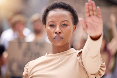 Youll get nothing more from me. Shot of a young woman holding her hand up to stop at a protest.