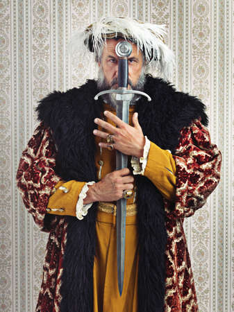 I rule by the sword. Shot of a king holding a sword.の写真素材
