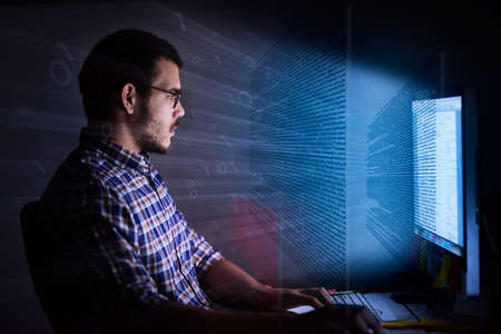 Ready, set, code. Cropped shot of a young computer programmer looking through data.の写真素材