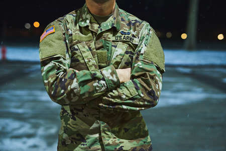 True soldiers stand their ground. Cropped shot of a soldier standing outside on a cold night at a military academy.の写真素材