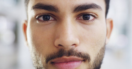 The face of success. Cropped shot of a young handsome businessman in a modern office.の写真素材