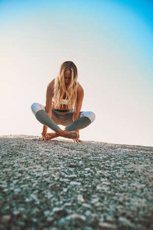 Be a better you, for you. Shot of an athletic young woman practicing yoga on the beach.の写真素材