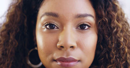 Facing the business world boldly. Cropped shot of a young beautiful businesswoman in a modern office.の写真素材