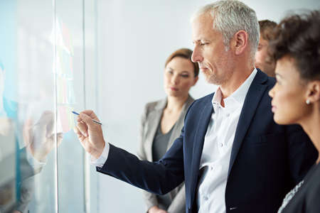 Exploring different ways to work their project. Shot of a group of colleagues having a brainstorming...
