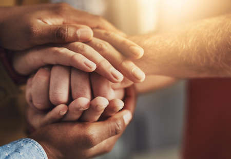 Many hands, one mind. Shot of a group of people putting their hands together.の写真素材