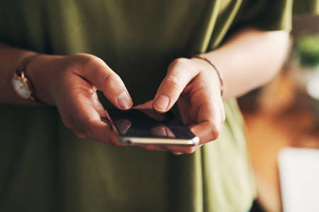 The best notifications come from new clients. Shot of an unrecognisable woman using a smartphone...