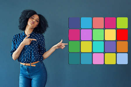 Signs of the digital times. Studio shot of a young woman pointing towards various notification icons...
