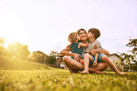 Kiss delivery for mom. Cropped shot of a young family spending time together outdoors.