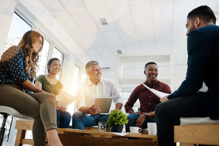All minds together make for the ultimate creativity. Shot of creative employees working in a modern...