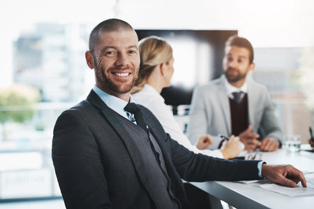 Were here to get the job done. Portrait of a mature businessman sitting in an office with his...