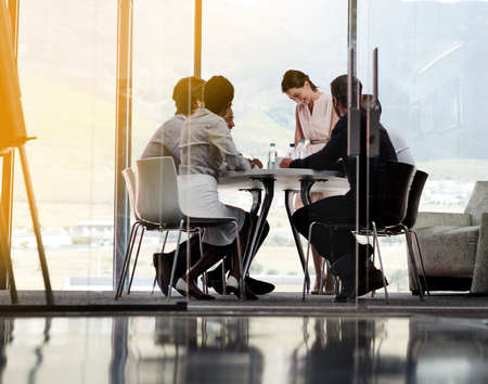 Feeling positive about todays meeting. Shot of a businesswoman giving a presentation to a group of...