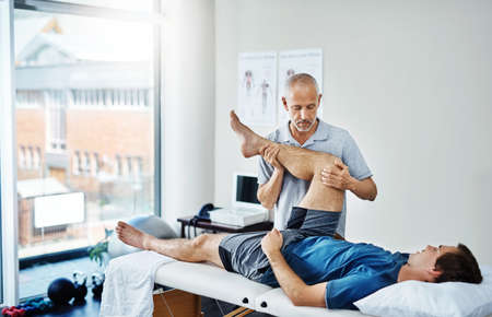 Lets get this leg healed. Shot of a physiotherapist treating a patient.