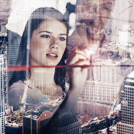 Its all about the details. Multiple exposure shot of a city skyline superimposed on businesspeople brainstorming.の写真素材