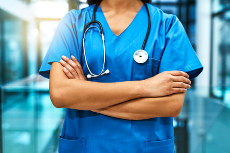 These hands will take care of you. Shot of an unrecognisable nurse standing in a hospital.の写真素材