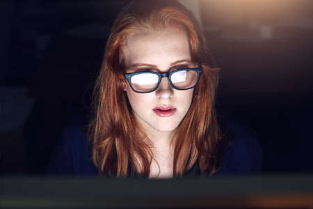 I only have so much room on my plate. Shot of a young businesswoman working late in her office.