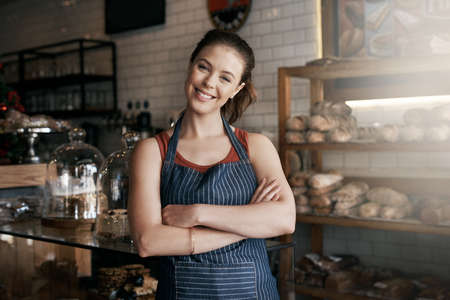 Follow your passion and success will follow. Portrait of a confident young woman working in a coffee shop.の写真素材
