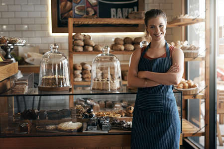 Determine whether owning your own business is for you. Portrait of a confident young woman working in a coffee shop.の写真素材