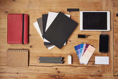 Creativity is an occupation. High angle shot of wireless technology on a wooden table.の写真素材