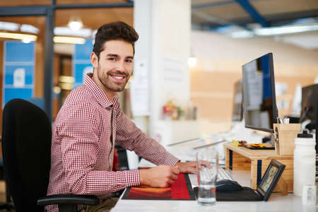 This is my space to create. Shot of a young businessman sitting at his desk.