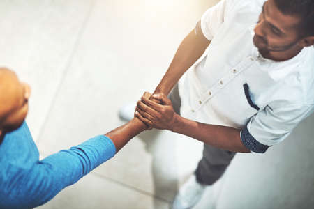 The warmest of welcomes. Shot of businesspeople shaking hands in an office.