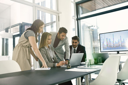 Presenting ideas to the team. Shot of corporate businesspeople meeting in the boardroom.の写真素材