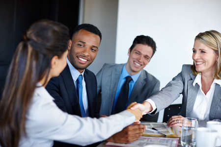 We hope to see you on Monday. Shot of professional coworkers shaking hands during a meeting in the...