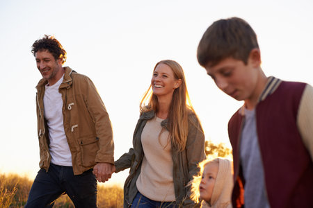 Making time for the family. Shot of a happy family out on a morning walk together.の写真素材