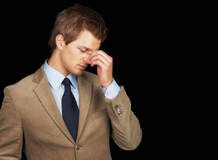 Stressed out business man over black background. Stressed out young business man over black...