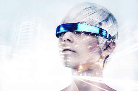 Envisioning the future. Multiple exposure shot of a young woman with VR glasses superimposed on a city at night.の写真素材
