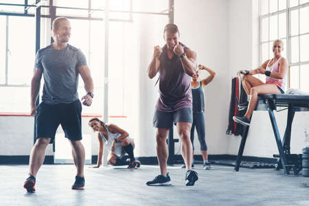 Success is a series of small wins. Shot of a fitness group celebrating a victory at the gym.