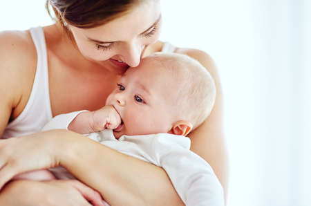 Tender moments with Mom. Shot of an adorable baby boy bonding with his mother at home.