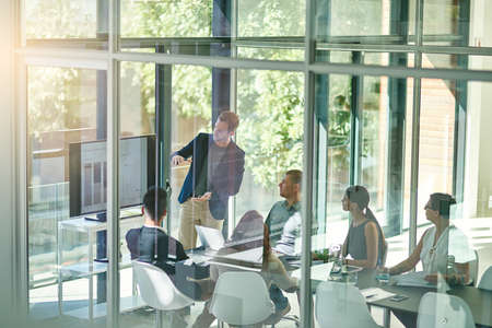 Going through all the information. Shot of a group of businesspeople meeting in the boardroom.