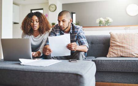 We may need to tap into the emergency fun. Shot of a young couple going through their paperwork...