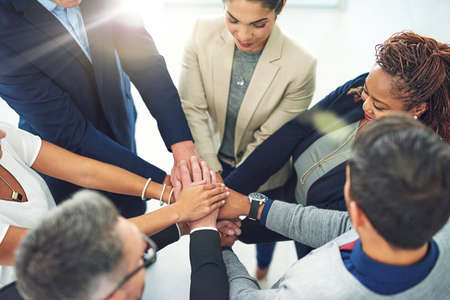 Success is the product of teamwork. Shot of corporate colleagues working together in their office.の写真素材