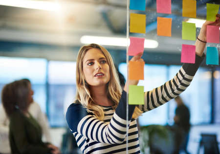 Attaining success with a well mapped out plan. Shot of a young woman having a brainstorming session...