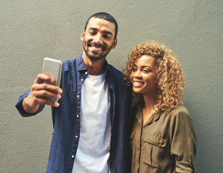 Capturing the moments to look back at it later. Shot of a young couple taking a selfie together...