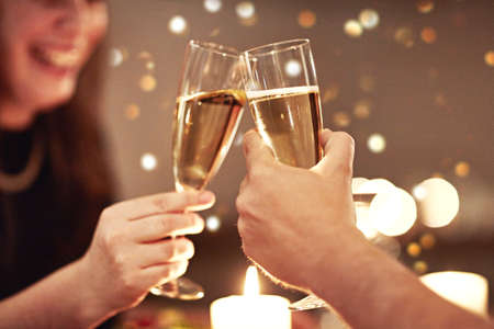 Heres to a love worth celebrating. Cropped shot of a couple toasting during a romantic dinner.の写真素材