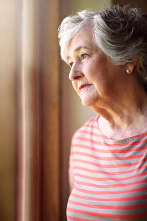 I remember the days.... Shot of a senior woman looking thoughtful.の写真素材