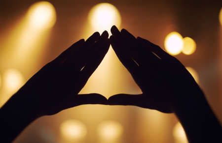 Gesturing with the music. Cropped shot of a persons hands at a music concert.